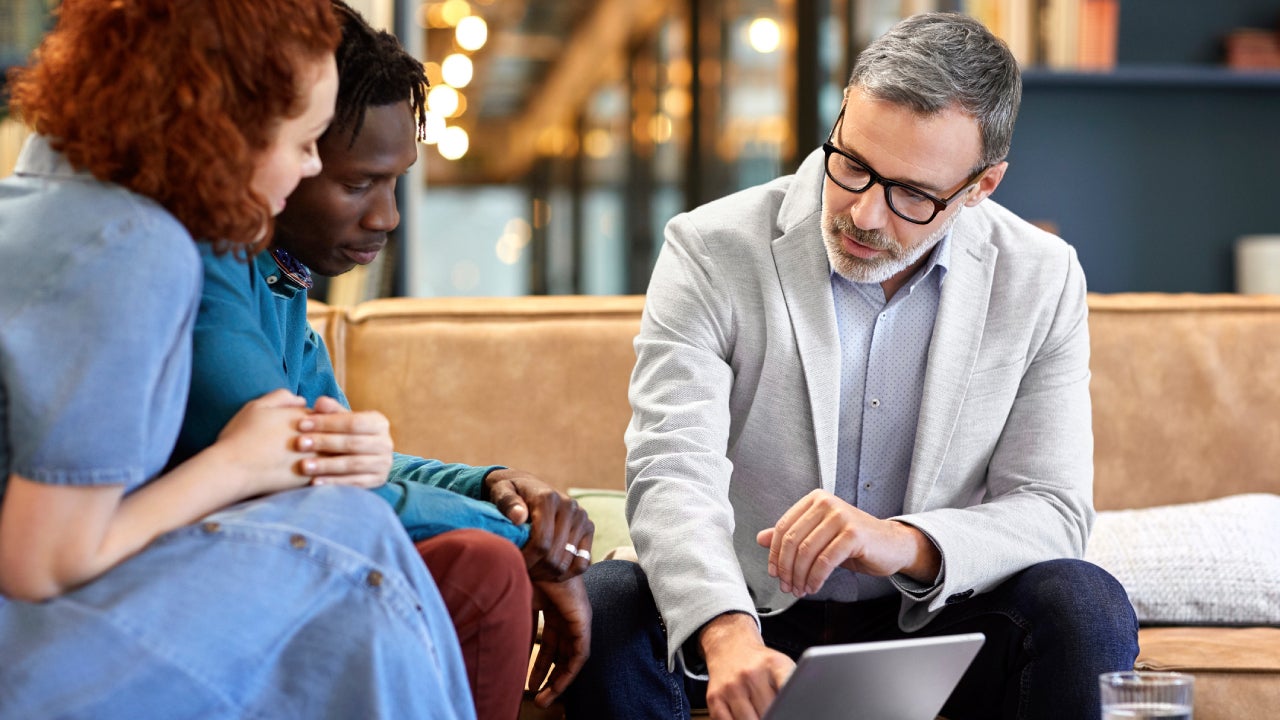 Financial advisor planning with clients at office